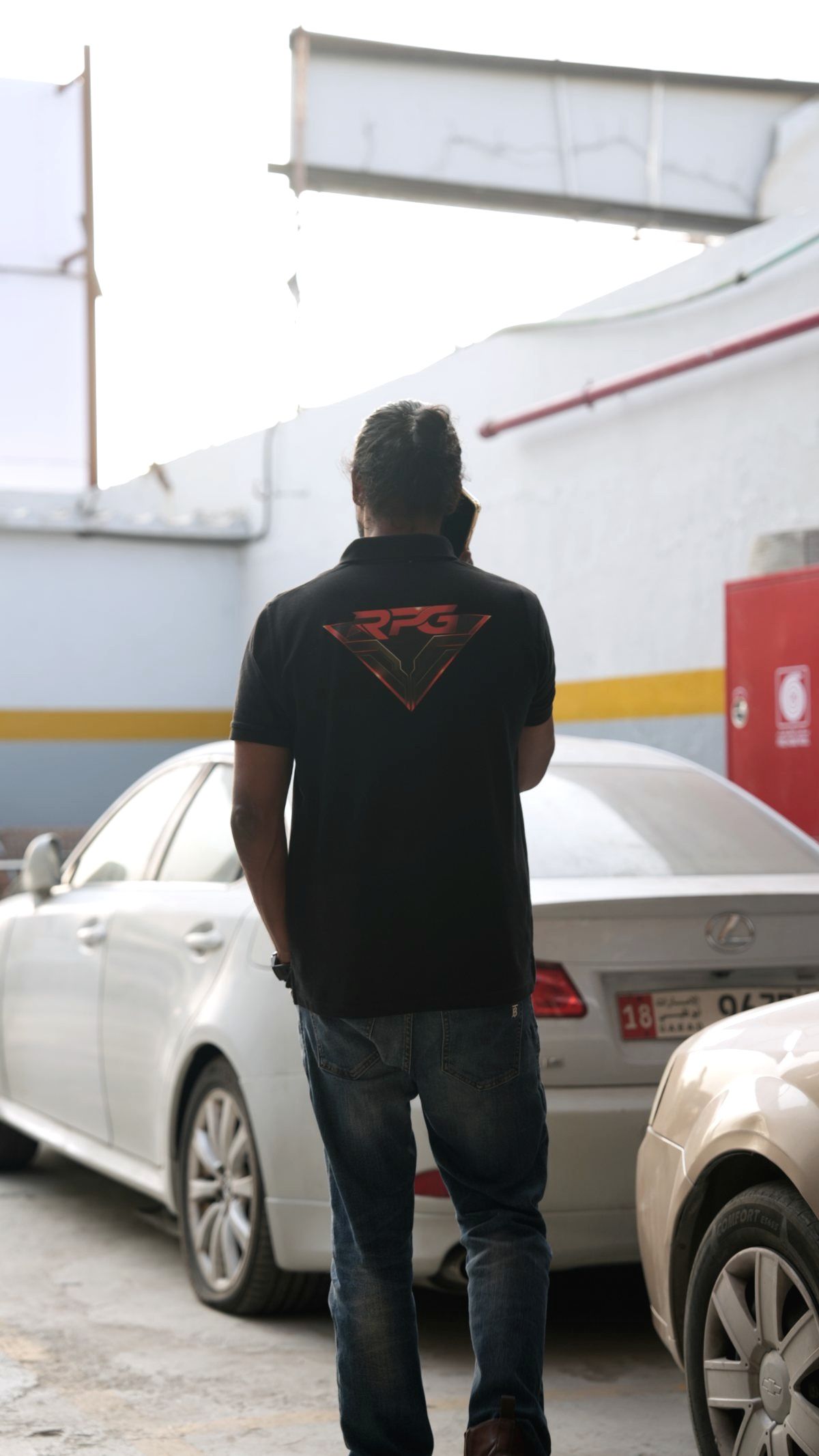 Rogue Performance Garage team member in a branded polo shirt in the yard