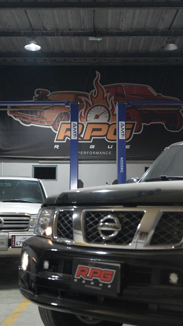 Black Nissan Patrol front grille lit inside the Rogue Performance Garage workshop
