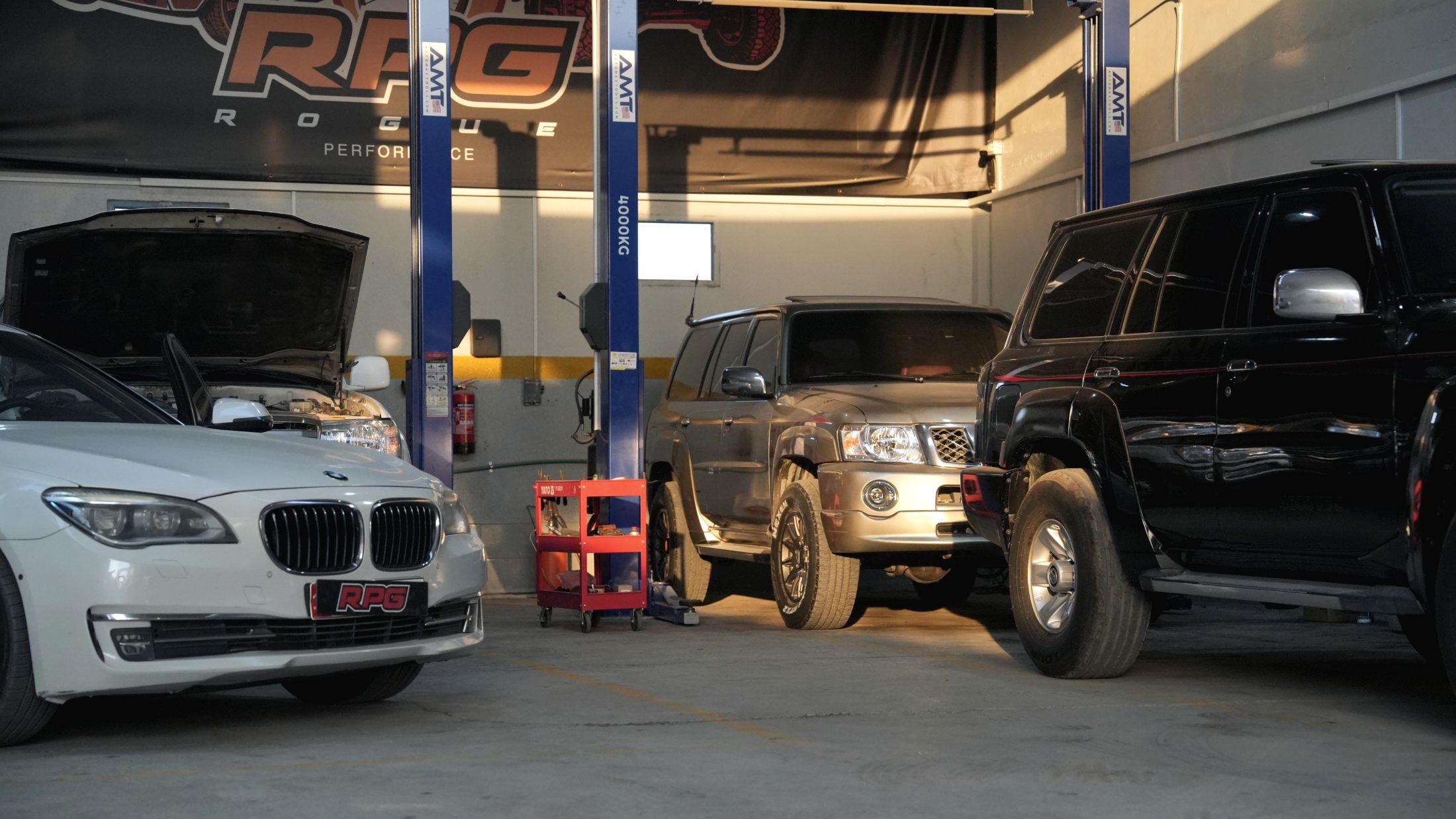 Vehicles on two-post lifts inside the Rogue Performance Garage workshop in Mussafah M32, Abu Dhabi